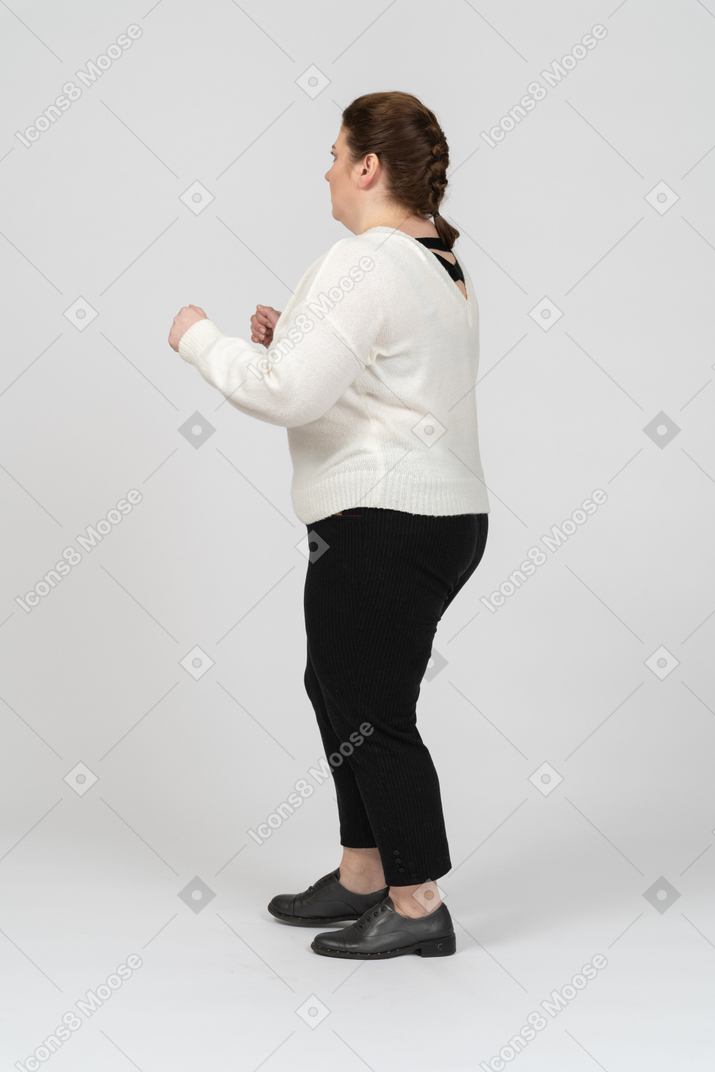 Plump woman in white sweater is ready to fight