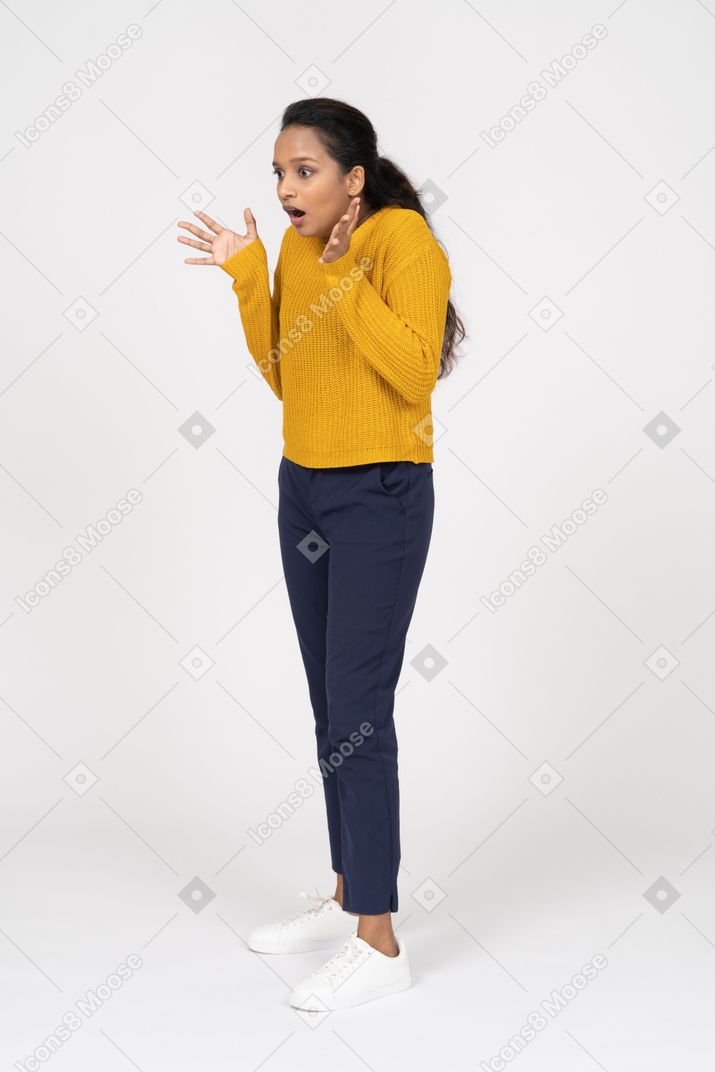 Side view of an impressed girl in casual clothes