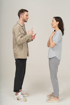 Side view of young couple speaking to each other