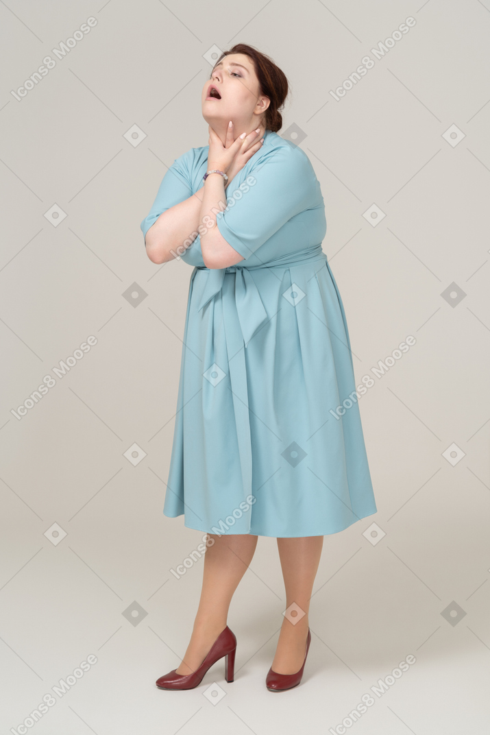 Front view of a woman in blue dress chocking herself