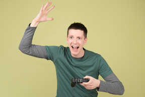 Happy and excited young man holding a joystick