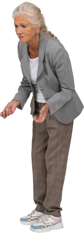 Side view of an old lady in suit bending down and explaining something