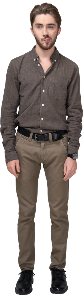 Front view of a confused young man in office clothing standing still