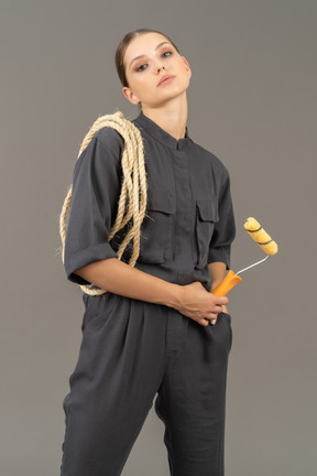 Confident woman holding a paint roller