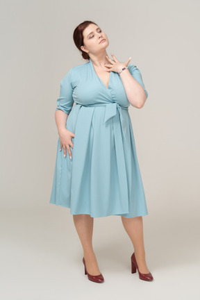 Front view of a woman in blue dress posing