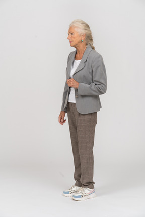 Old lady in suit standing in profile