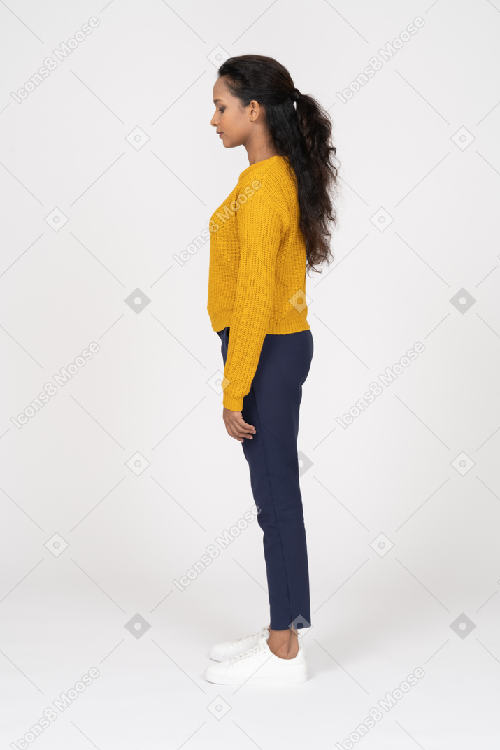 Beautiful girl in casual clothes standing in profile