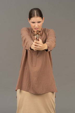 Young christian lady hold a cross in front of her