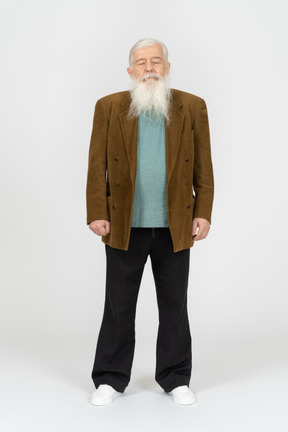 Old man with his arms at sides and eyes closed