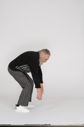 Side view of an old man bending over