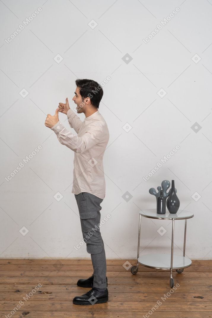 Side view of a happy man in casual clothes gesturing