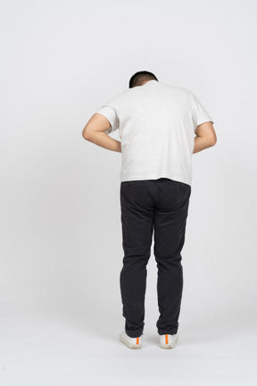 Rear view of a man suffering from stomachache