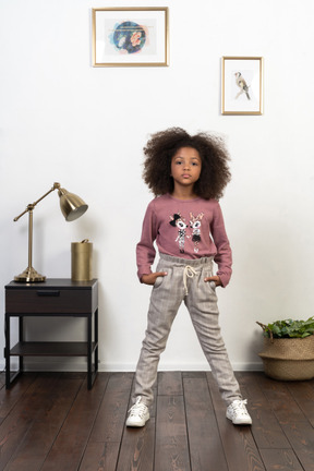 Cute girl kid posing on the apartments background