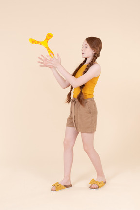 Teenage girl playing with boomerang