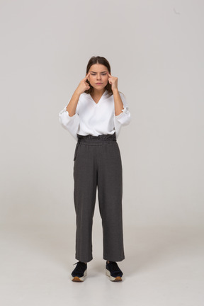 Front view of a young lady in office clothing with bad eyesight