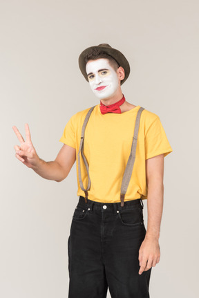 Male clown showing peace signs