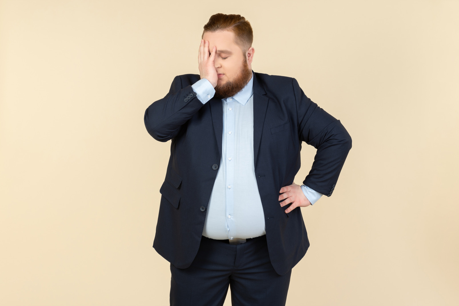 Sick and tired young overweight man closing face with a hand