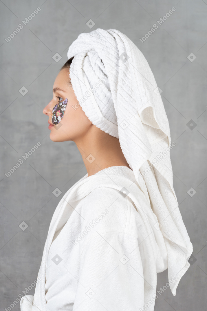 Vista lateral de una mujer en bata de baño