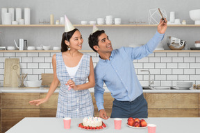 A man and woman celebrating a birthday with a cake