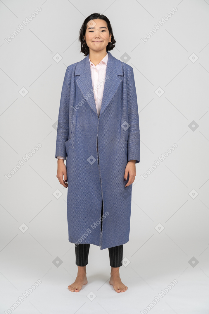 Woman in blue coat smiling cheerfully
