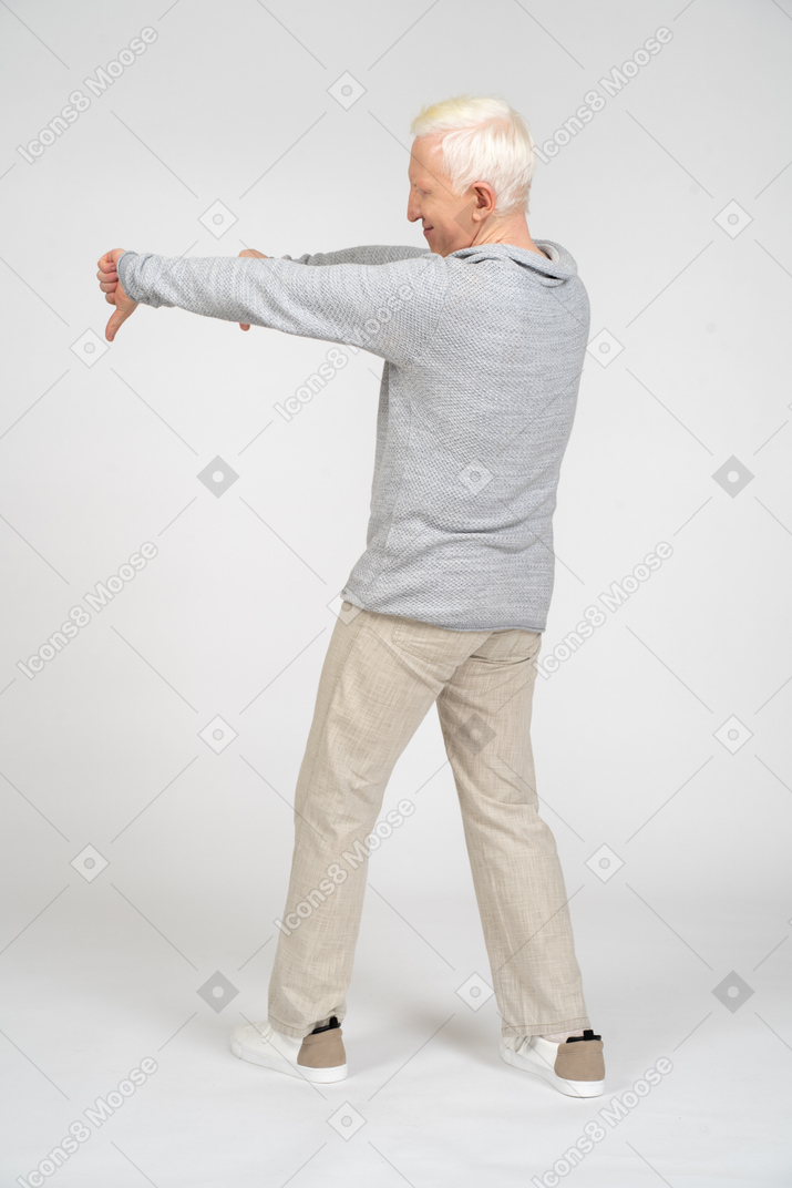 Rear view of man giving thumbs down with two hands