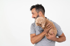 Красивый зрелый мужчина держит щенка