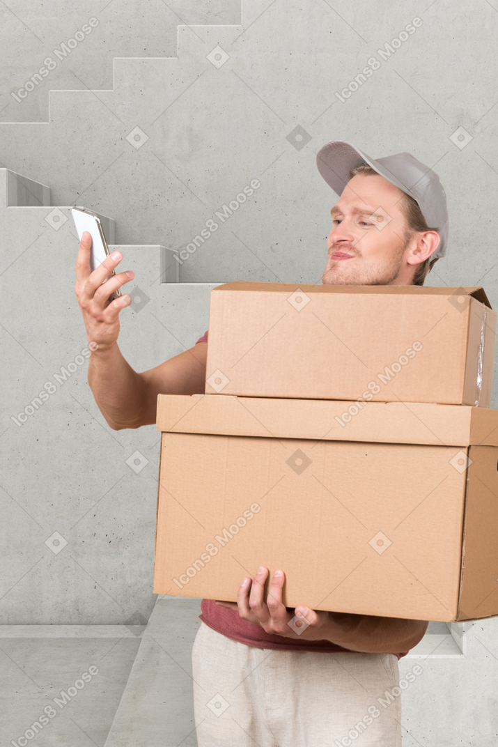 A delivery man holding boxes