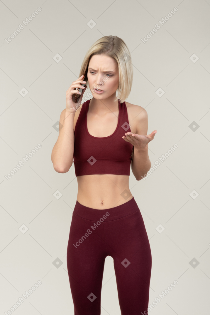 Bothered young woman talking on the phone