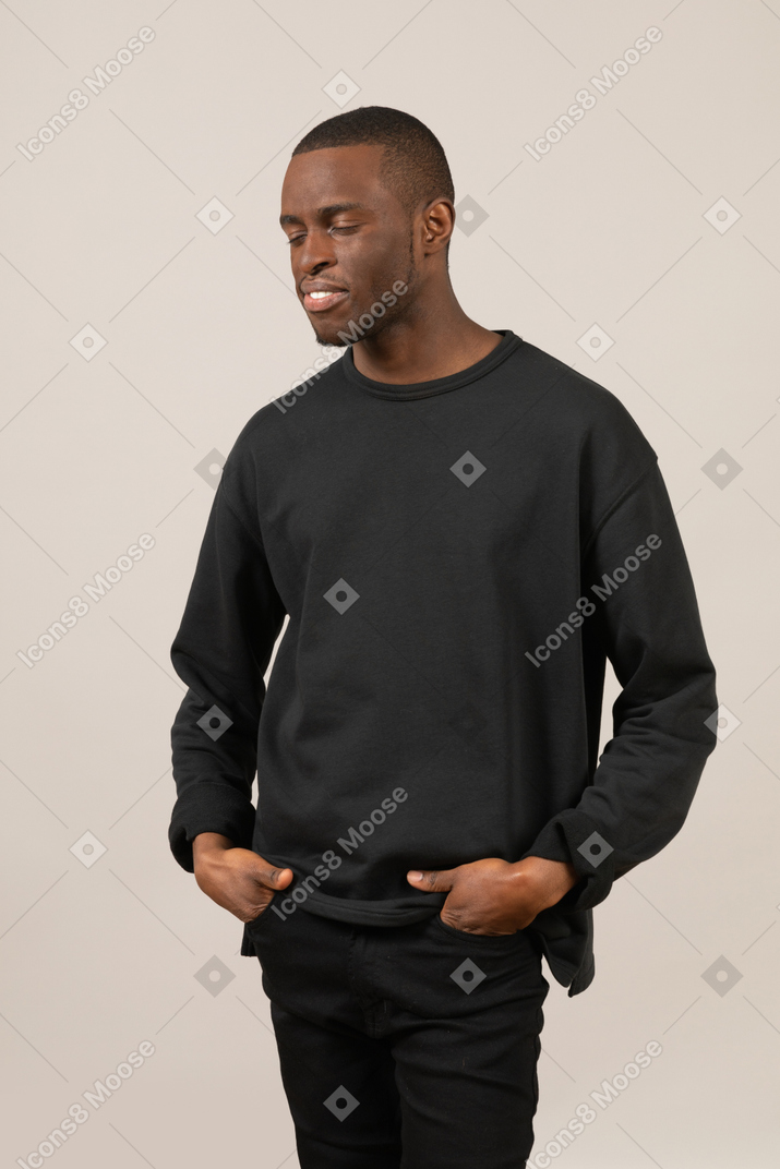 Man with hands in pockets closed eyes