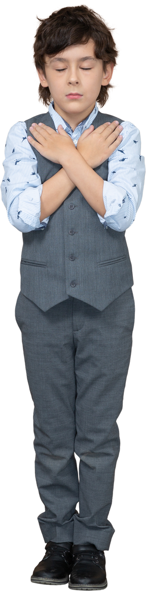 Front view of a boy in grey suit standing with hands on shoulders