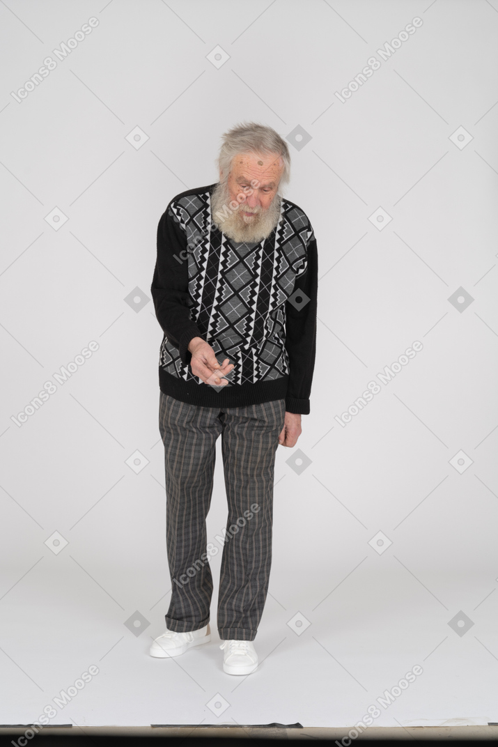 Front view of an elderly man reaching out for something