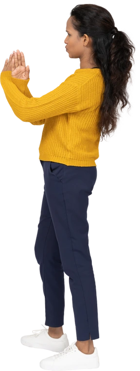 Side view of a girl in casual clothes showing stop gesture