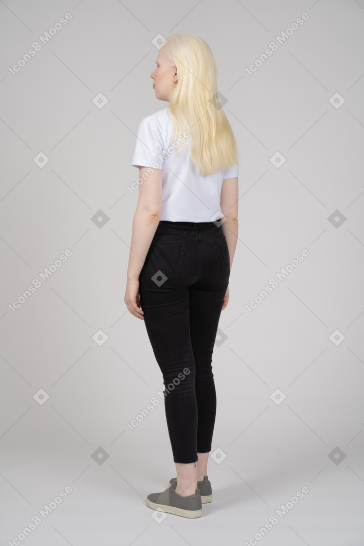 Back view of a standing blonde girl