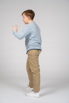 Side view of a boy showing size of something