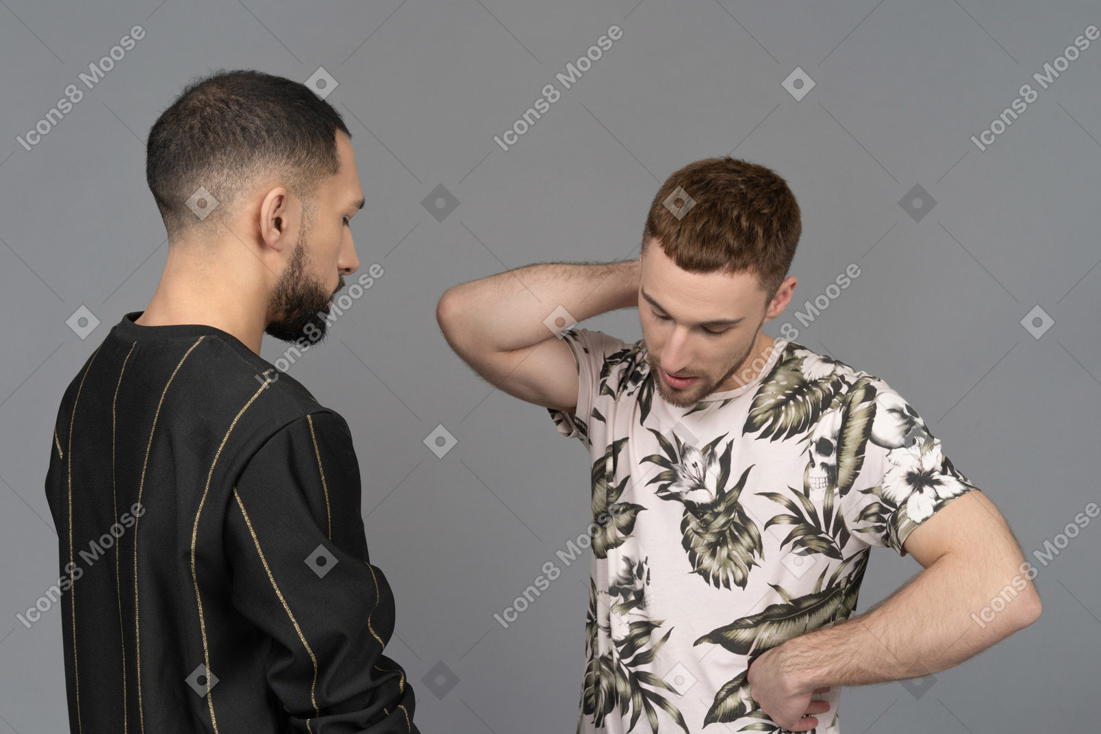 Couple of two young caucasian men looking troubled and stressed as if they're arguing