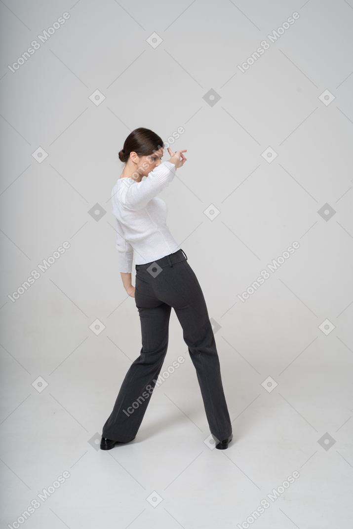 Rear view of a woman in suit dancing