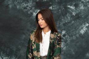 Close-up of a woman in silk japanese jacket looking down