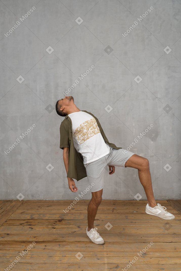 Man in casual clothes throwing his head back