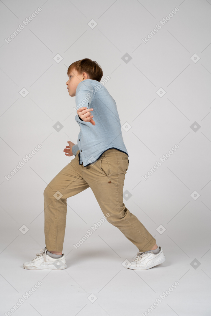 A boy taking big steps while walking
