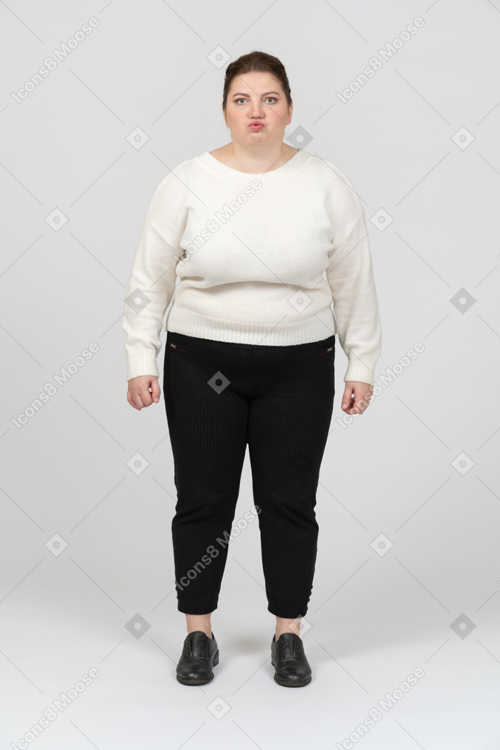 Plump woman in casual clothes making faces