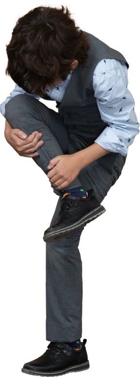 Front view of a boy in grey suit stretching leg