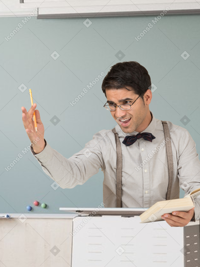 A man in a bow tie is holding a pencil