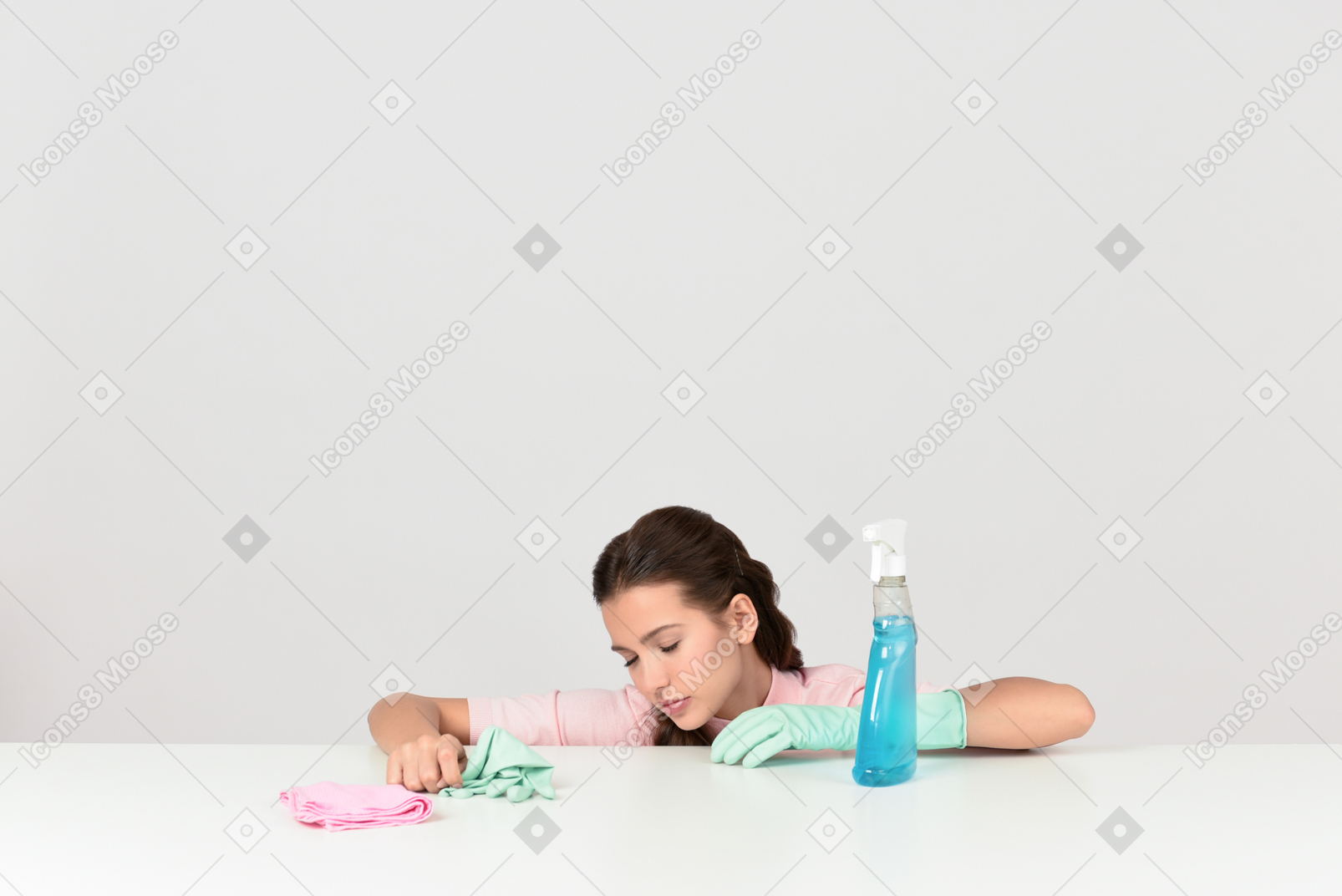 Attractive young woman looking tired while doing household chores