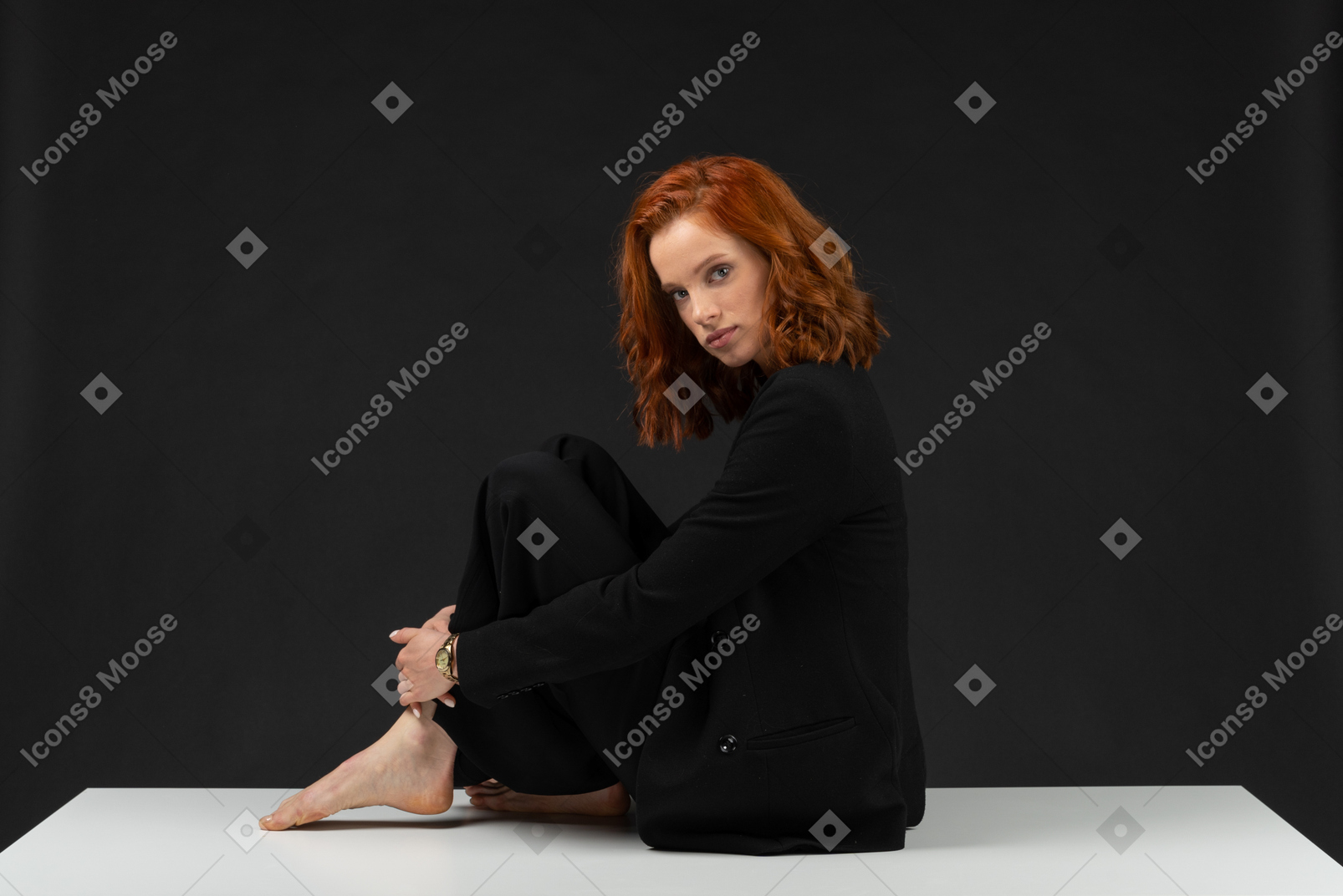 Lonely girl sitting on the white table