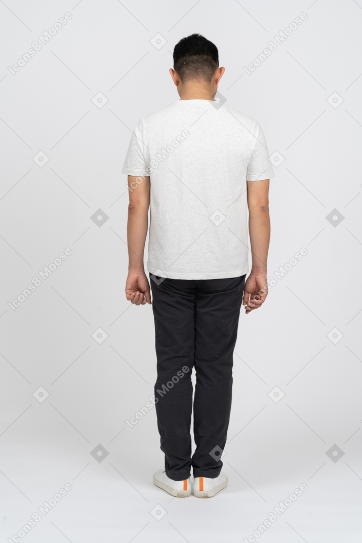 Rear view of a man in casual clothes looking down