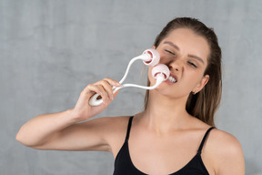 Close-up of a young woman aggressively massaging her face