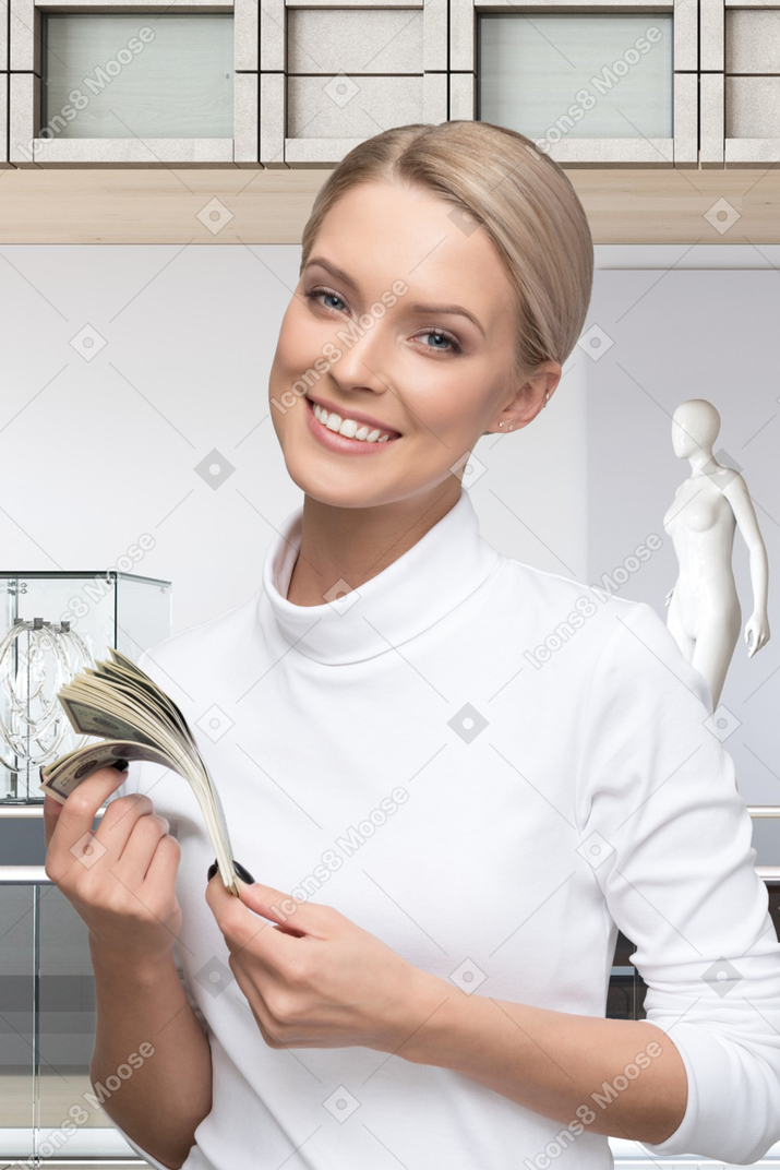 Woman holding a stack of money in her hands