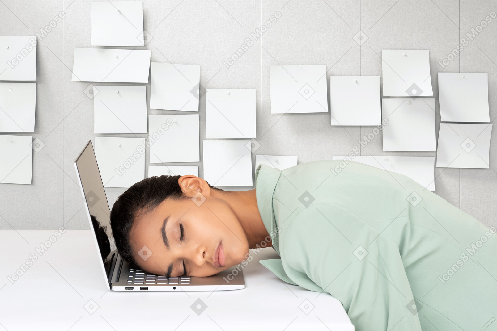 A woman is sleeping on a laptop computer
