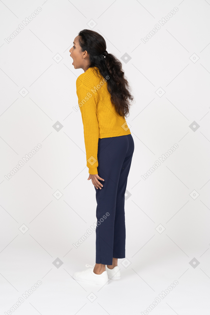 Side view of a girl in casual clothes shouting