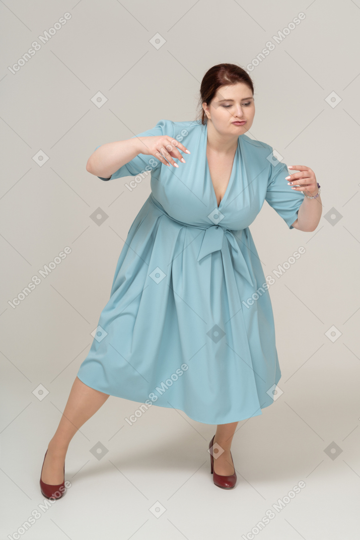 Front view of a woman in blue dress exercising